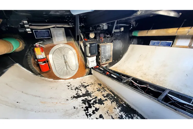 Slide: The Image of Interior of 2002 Custom International Americas Cup Class yacht, featuring equipment and fire extinguisher. - 36