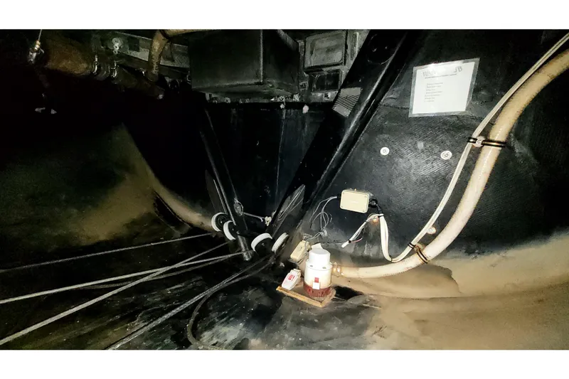 Slide: The Image of Interior view of a 2002 Custom International Americas Cup Class yacht, showcasing cables and equipment. - 37