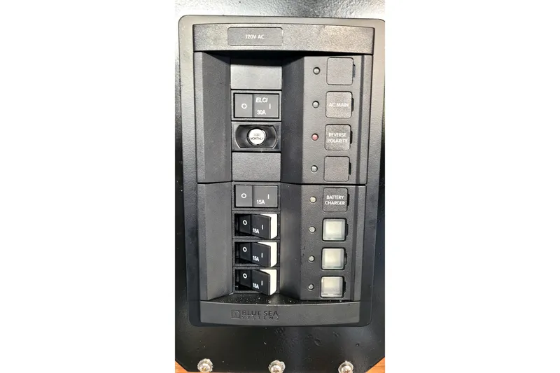 Slide: The Image of Electrical panel with switches and indicators on a 2002 Custom International Americas Cup Class boat. - 42