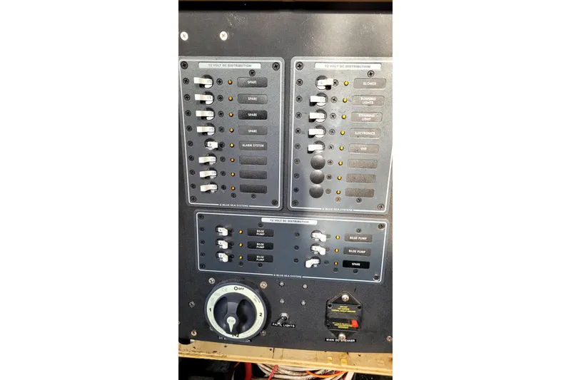 Slide: The Image of Control panel of a 2002 Custom International Americas Cup Class yacht, featuring switches and dials. - 43