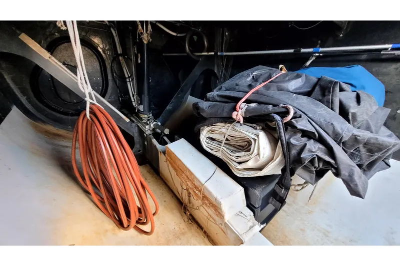 Slide: The Image of Interior of a 2002 Custom International Americas Cup Class yacht with coiled rope and folded sails. - 67