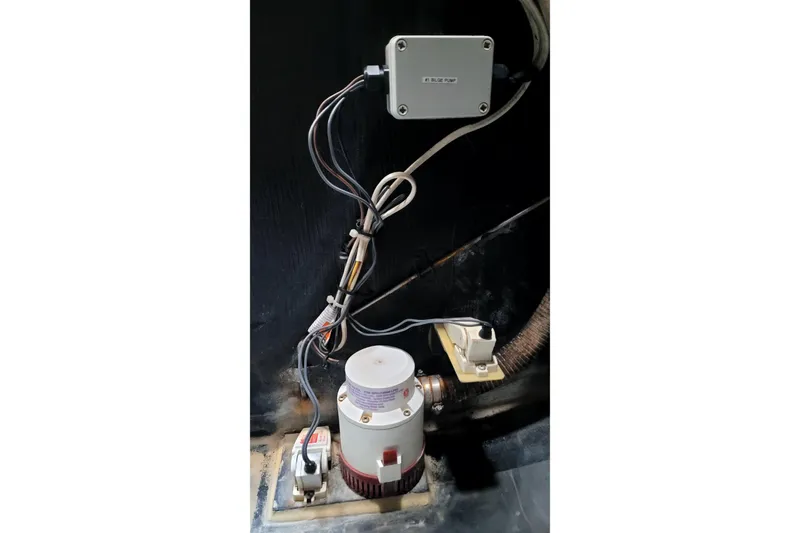 Slide: The Image of Electrical wiring and pump system inside a 2002 Custom International Americas Cup Class boat. - 69