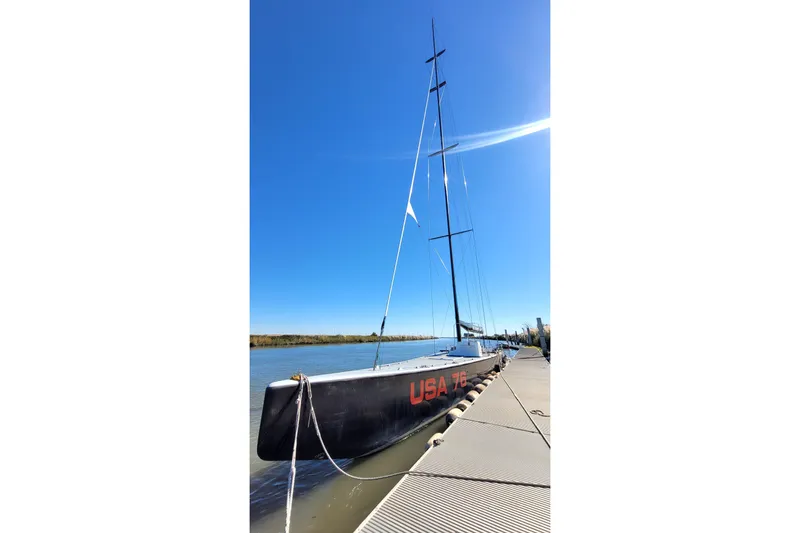 Slide: The Image of Sleek 2002 Custom International Americas Cup Class yacht docked under clear blue sky. - 78
