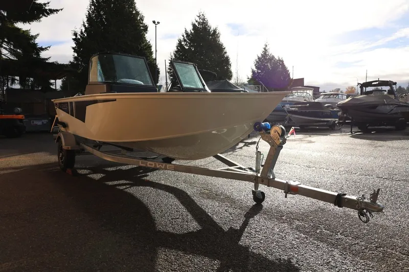 Slide: The Image of 2026 Lowe Fishing Machine 1675 WT on trailer in sunny outdoor setting. - 11