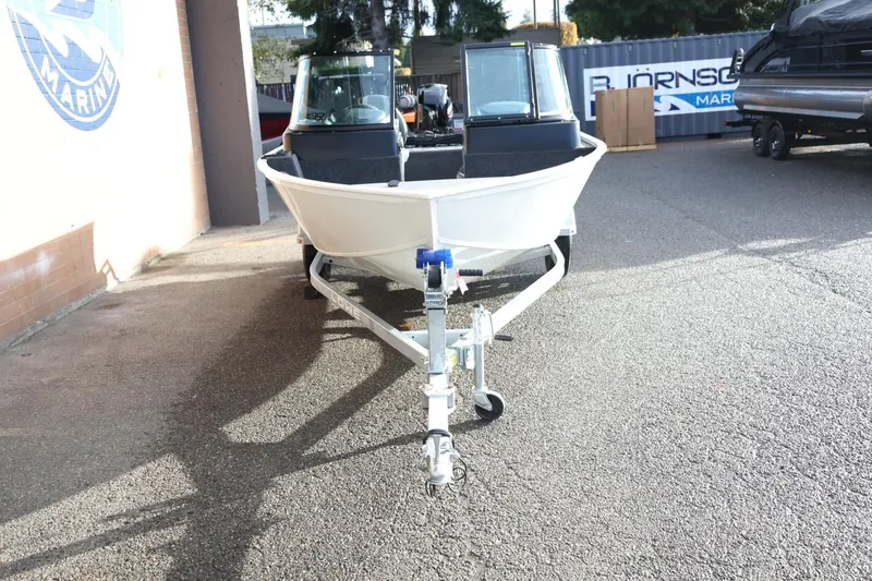 Slide: The Image of 2026 Lowe Fishing Machine 1675 WT on trailer, parked outdoors. - 12
