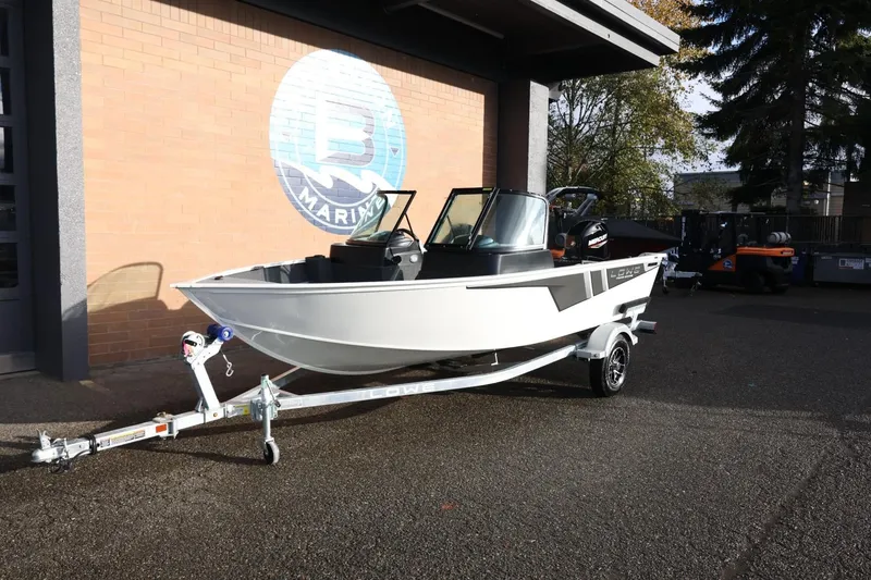 Slide: The Image of 2026 Lowe Fishing Machine 1675 WT boat on trailer outside marine shop. - 14