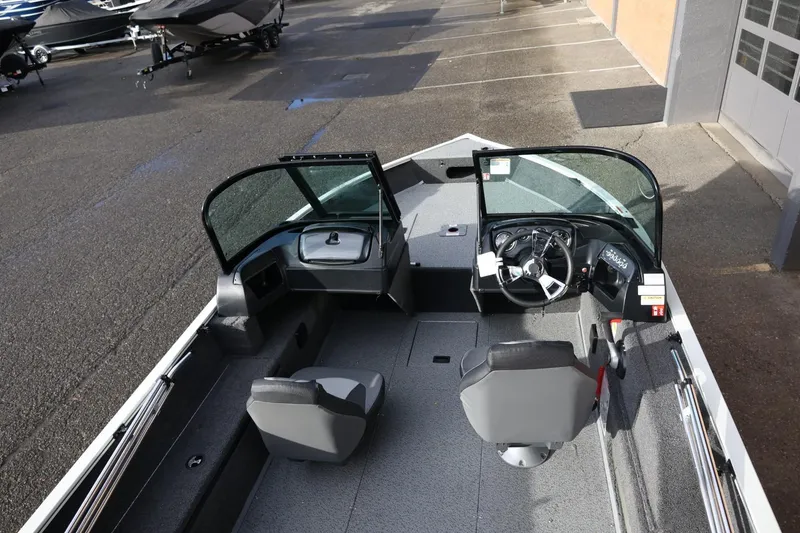 Slide: The Image of 2026 Lowe Fishing Machine 1675 WT interior with dual seats and steering console. - 17