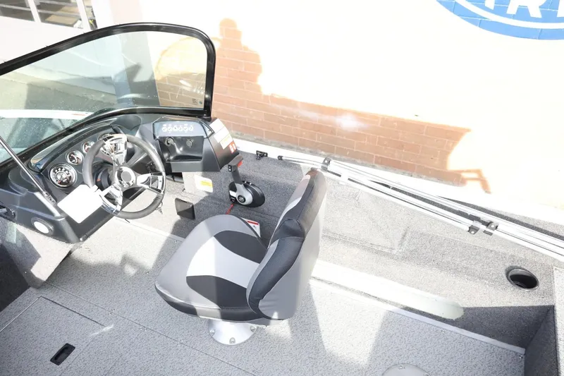 Slide: The Image of 2026 Lowe Fishing Machine 1675 WT interior with steering wheel and seat. - 20