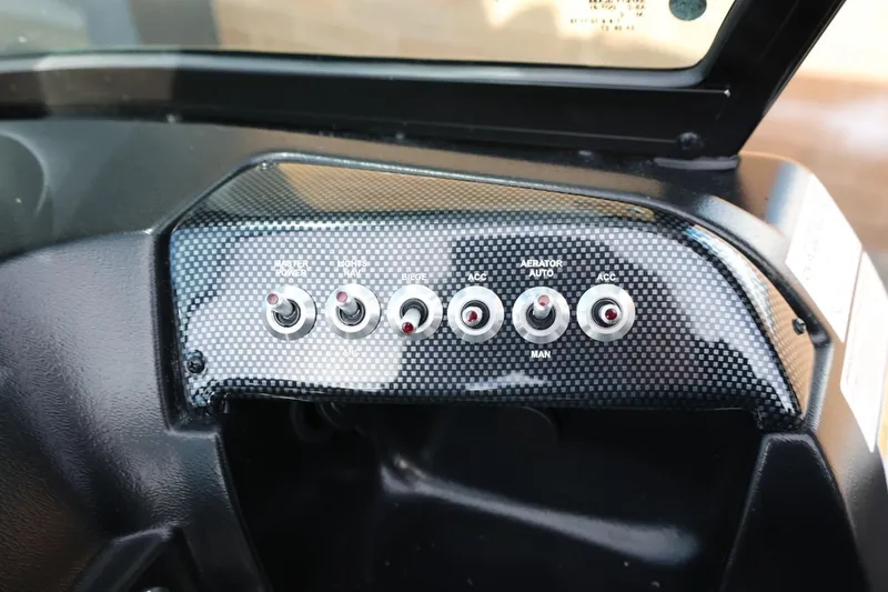 Slide: The Image of Control panel of 2026 Lowe Fishing Machine 1675 WT with toggle switches. - 22