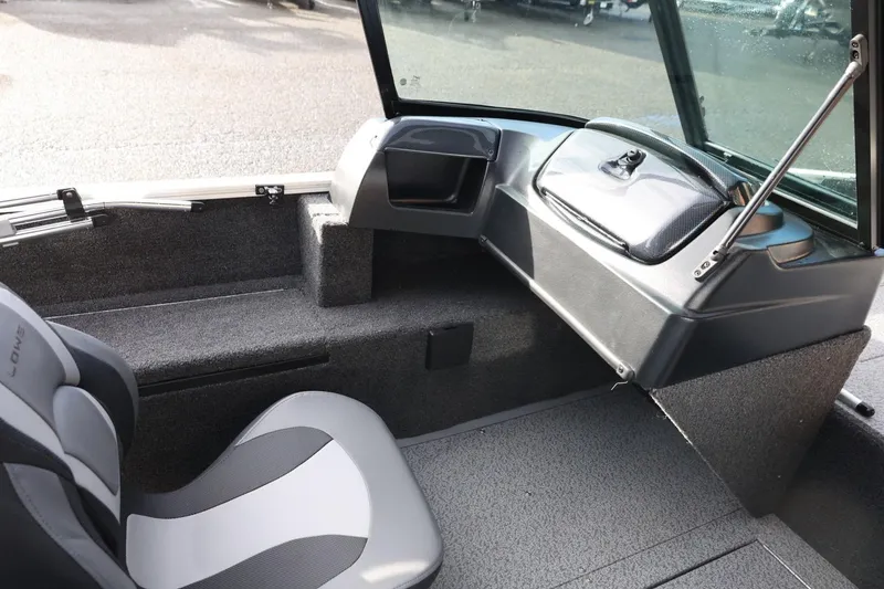 Slide: The Image of 2026 Lowe Fishing Machine 1675 WT interior with seating and dashboard view. - 25