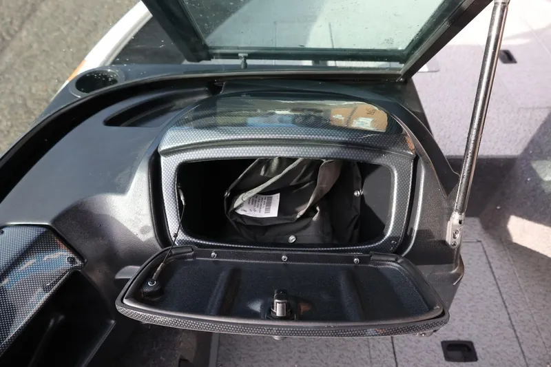 Slide: The Image of 2026 Lowe Fishing Machine 1675 WT storage compartment with open lid and interior view. - 27