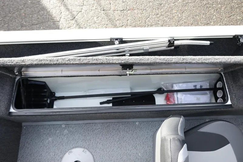 Slide: The Image of 2026 Lowe Fishing Machine 1675 WT storage compartment with fishing gear and accessories. - 29