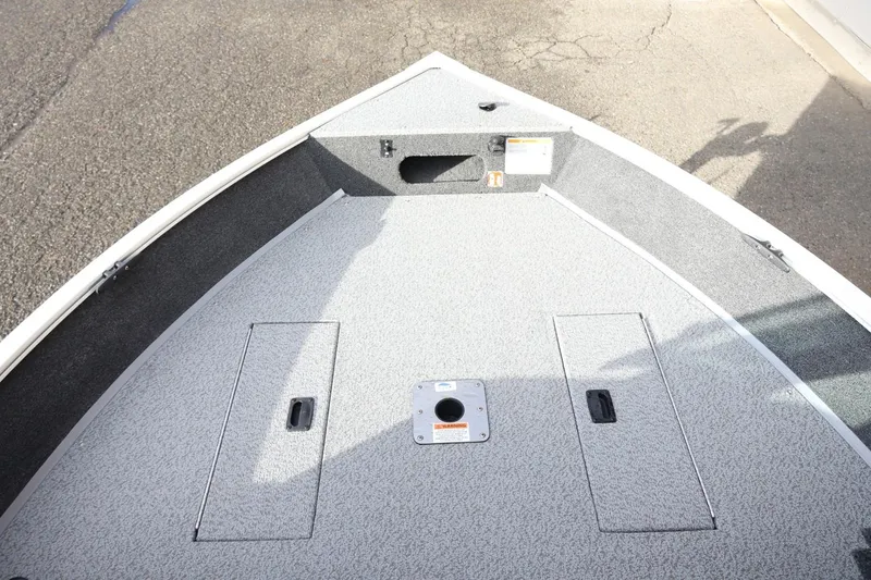 Slide: The Image of Bow deck of 2026 Lowe Fishing Machine 1675 WT, featuring storage compartments. - 32