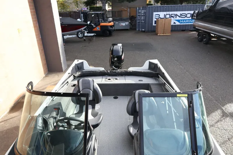 Slide: The Image of 2026 Lowe Fishing Machine 1675 WT boat in a marina setting. - 33