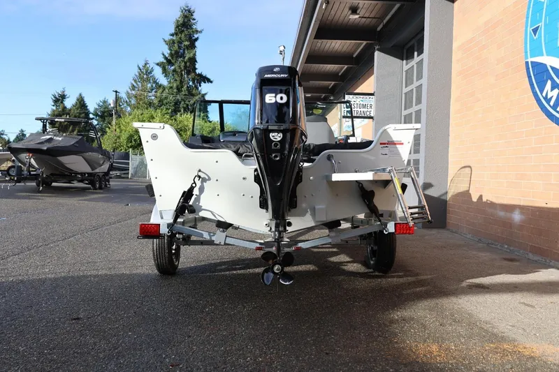 Slide: The Image of 2026 Lowe Fishing Machine 1675 WT on trailer, rear view with outboard motor. - 6