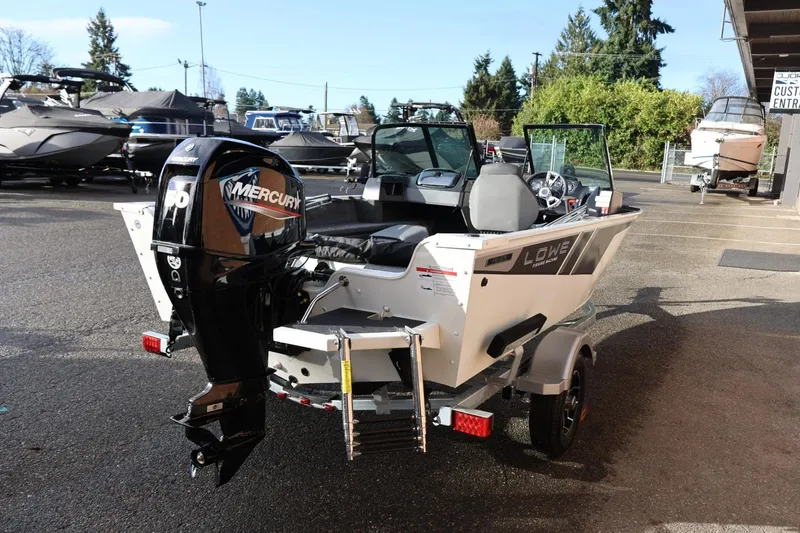Slide: The Image of 2026 Lowe Fishing Machine 1675 WT with Mercury outboard motor in a boatyard. - 7