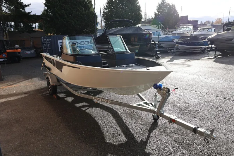 Slide: The Image of 2026 Lowe Fishing Machine 1675 WT boat on trailer in marina setting. - 9