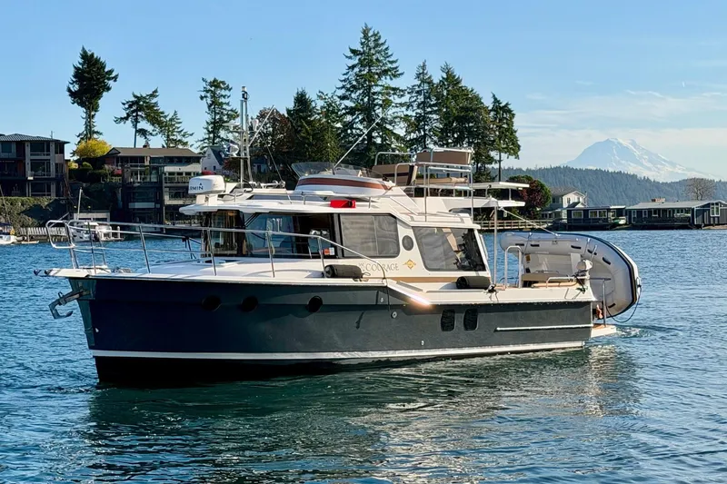 The Image of 2018 Ranger Tugs R-29 CB boat on scenic water with mountain backdrop. - 0