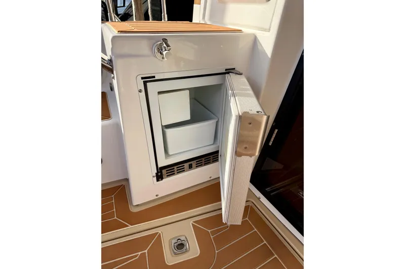 Slide: The Image of Open refrigerator on 2018 Ranger Tugs R-29 CB boat, showcasing interior storage space. - 12
