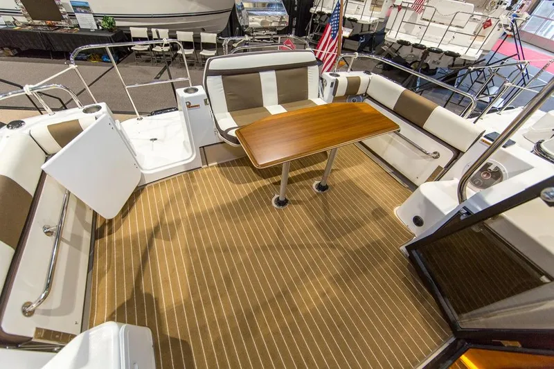 Slide: The Image of Manufacturer Provided Image: 2018 Ranger Tugs R-29 CB boat interior with seating and wooden table. - 14
