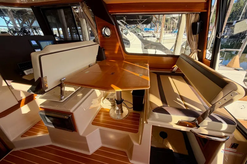 Slide: The Image of Interior of 2018 Ranger Tugs R-29 CB with wood accents and seating area. - 34