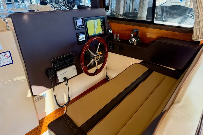 Slide: The Image of 2018 Ranger Tugs R-29 CB helm with navigation equipment and wooden steering wheel. - 36