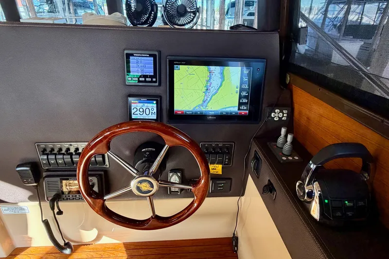 Slide: The Image of 2018 Ranger Tugs R-29 CB helm with navigation screens and wooden steering wheel. - 37