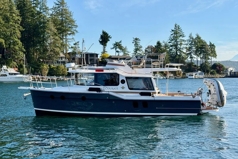 Slide: The Image of 2018 Ranger Tugs R-29 CB boat on scenic waterway with lush greenery. - 4