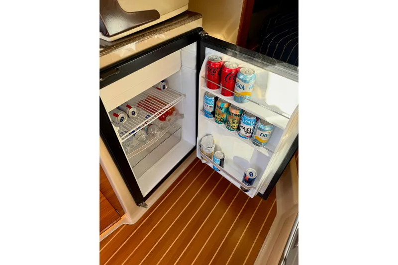Slide: The Image of Mini fridge stocked with beverages on 2018 Ranger Tugs R-29 CB boat. - 47