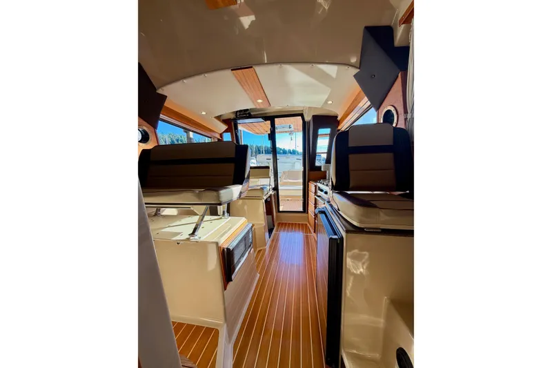 Slide: The Image of Interior of 2018 Ranger Tugs R-29 CB boat with wood flooring and seating. - 57