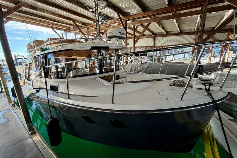 Slide: The Image of 2018 Ranger Tugs R-29 CB boat docked in a covered marina. - 62
