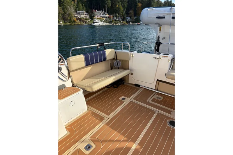 Slide: The Image of 2018 Ranger Tugs R-29 CB boat interior with tan seating and wood-style flooring. - 64