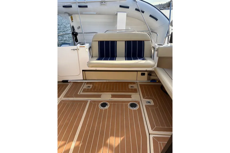 Slide: The Image of 2018 Ranger Tugs R-29 CB boat interior with cushioned seating and teak-style flooring. - 65