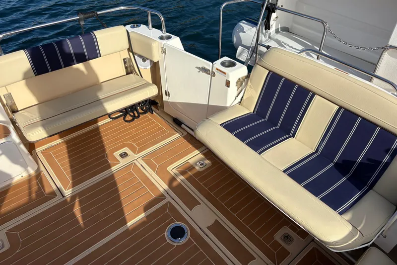 Slide: The Image of 2018 Ranger Tugs R-29 CB boat deck with cushioned seating and teak flooring. - 68