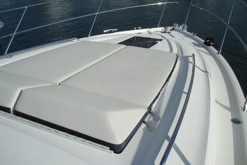 Slide: The Image of 2015 Princess V48 yacht with sunbathing deck, sleek design, and stainless steel railings. - 10