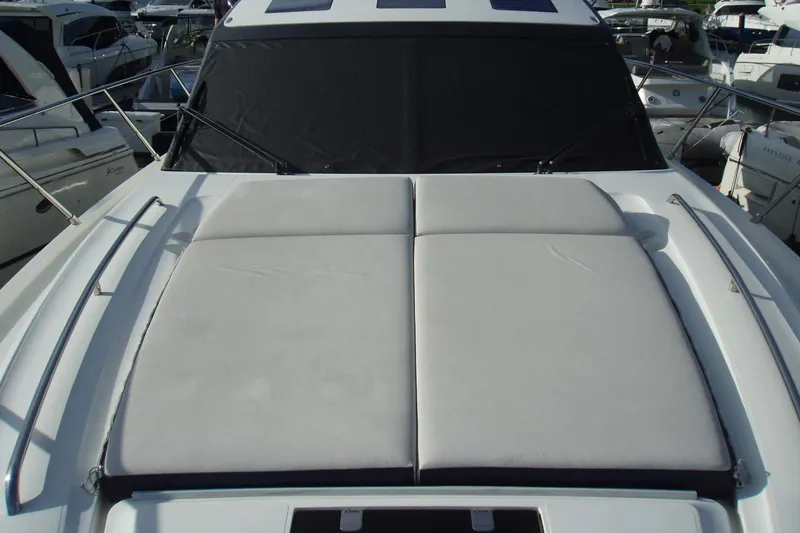 Slide: The Image of Sunpad on 2015 Princess V48 yacht, docked among other boats. - 11