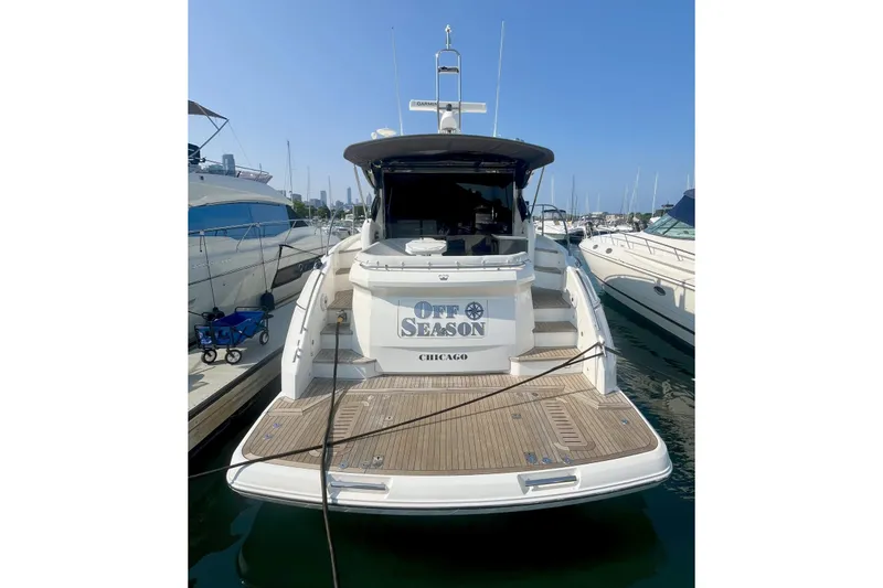 Slide: The Image of 2015 Princess V48 yacht docked, named "Off Season," in a marina setting. - 13