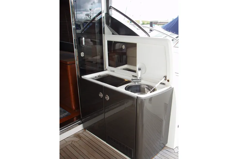 Slide: The Image of Outdoor kitchenette on 2015 Princess V48 yacht with sink and storage cabinets. - 16