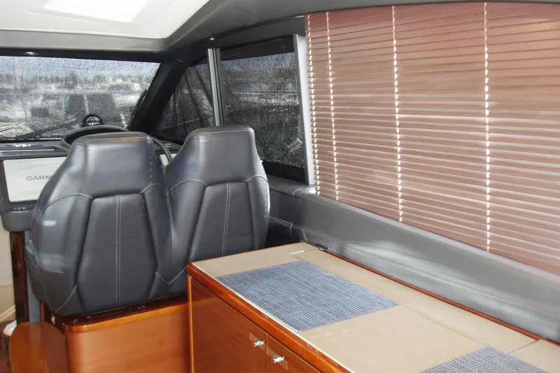 Slide: The Image of Interior of 2015 Princess V48 yacht with leather seats and wooden blinds. - 21