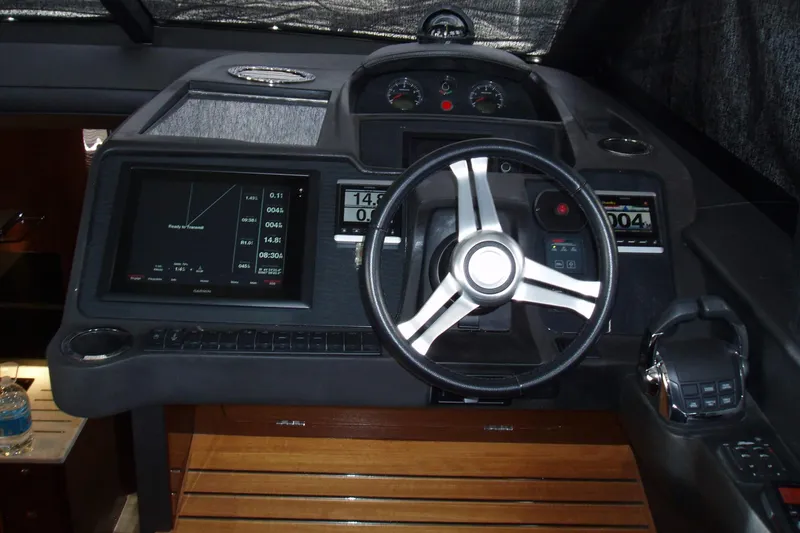 Slide: The Image of Cockpit of 2015 Princess V48 yacht with steering wheel and navigation displays. - 22
