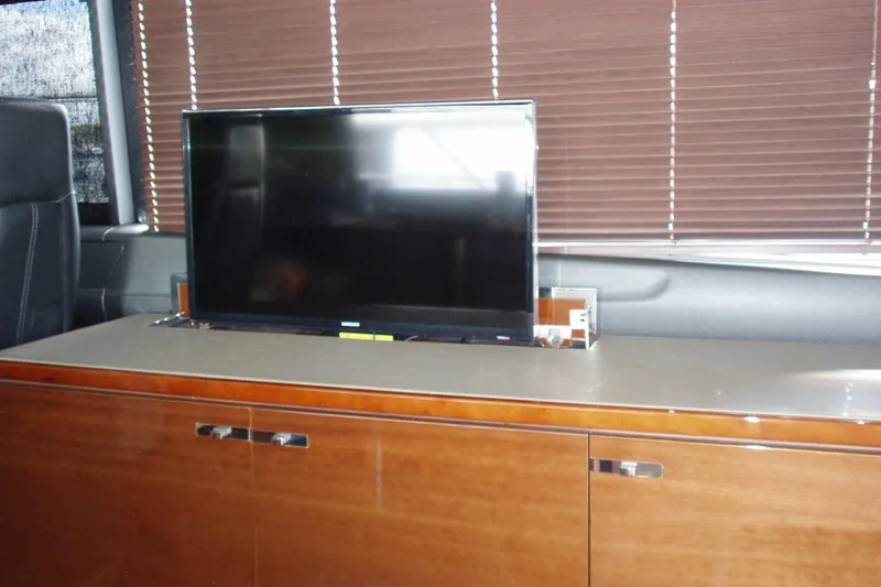 Slide: The Image of Interior of 2015 Princess V48 yacht with TV and wooden cabinetry. - 24