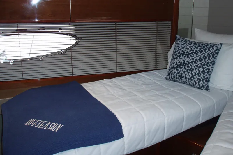 Slide: The Image of Interior cabin of 2015 Princess V48 yacht with cozy bedding and decorative pillow. - 27