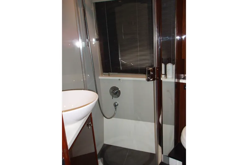 Slide: The Image of Luxurious bathroom in 2015 Princess V48 yacht with modern fixtures and glass shower. - 29