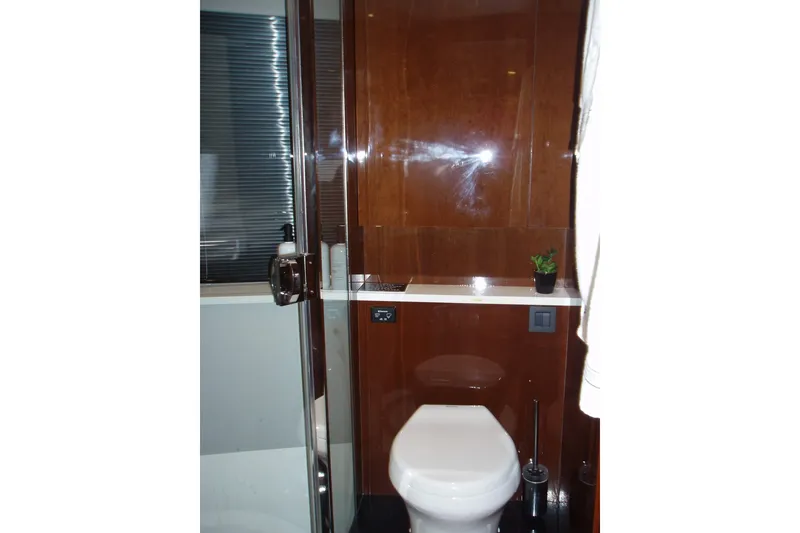 Slide: The Image of Luxurious bathroom in 2015 Princess V48 yacht with modern fixtures and wooden accents. - 30