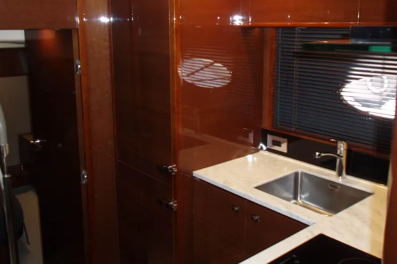 Slide: The Image of Luxurious kitchen interior of 2015 Princess V48 yacht with sleek wood finish and modern amenities. - 31