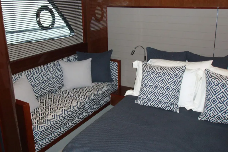 Slide: The Image of Luxurious interior of 2015 Princess V48 yacht with elegant bedding and seating. - 32