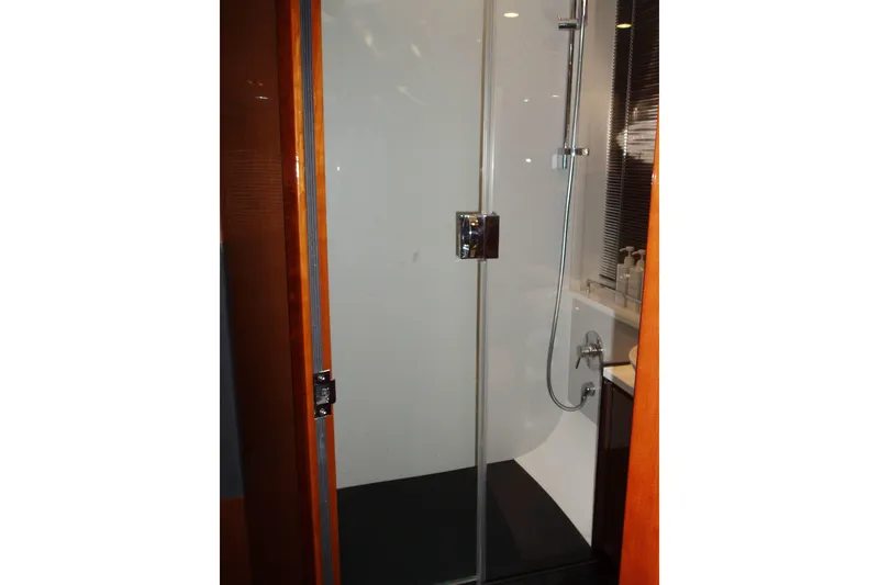 Slide: The Image of Shower area in 2015 Princess V48 yacht, featuring glass door and modern fixtures. - 35