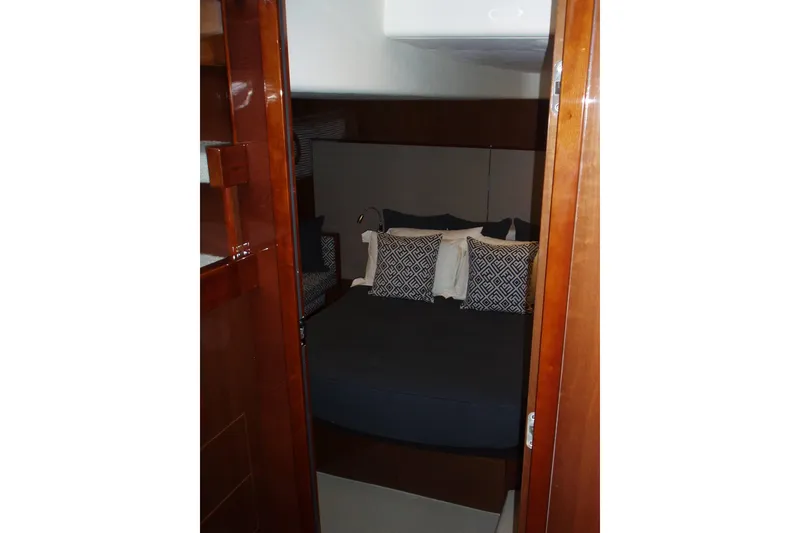 Slide: The Image of Luxurious cabin interior of 2015 Princess V48 yacht with elegant bedding and wooden finishes. - 37