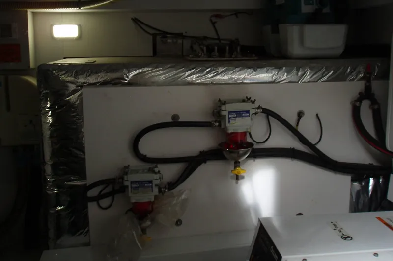 Slide: The Image of Engine room of a 2015 Princess V48 yacht with mechanical components and wiring. - 39