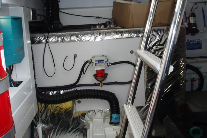 Slide: The Image of Engine room of a 2015 Princess V48 yacht with equipment and ladder. - 42